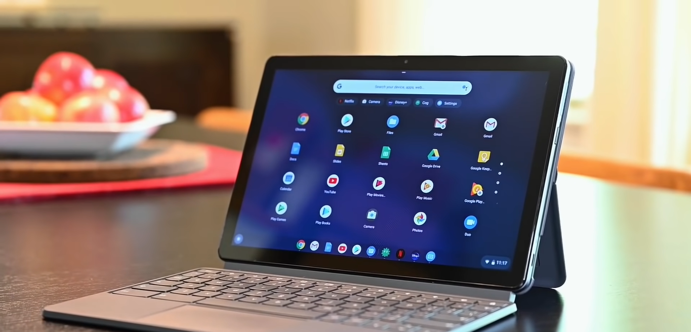 An open Lenovo Chromebook Duet 5 on top of a table with screen showing different apps
